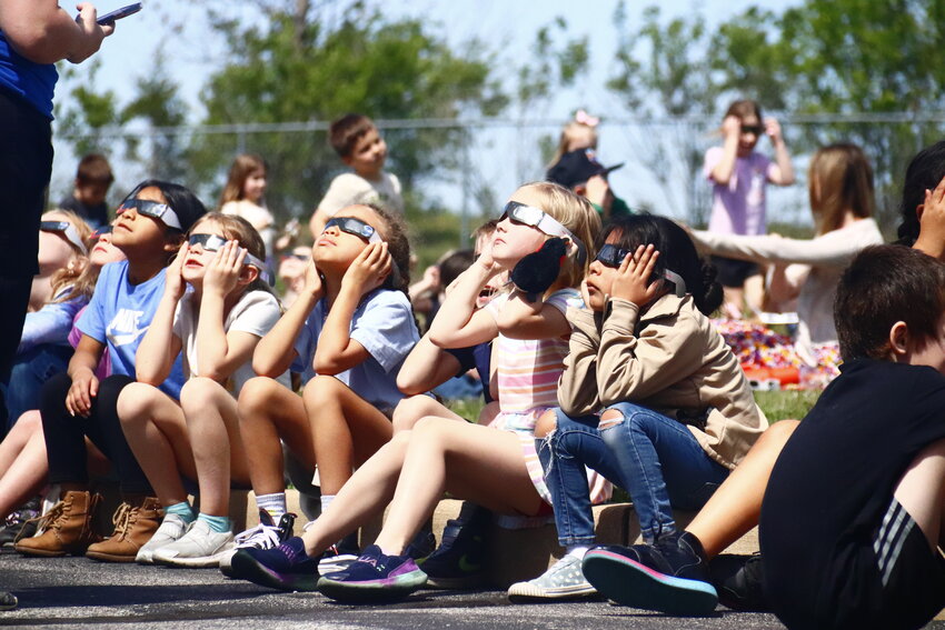 Students at Wright City East Elementary gathered outside with parents and teachers with their protective eyewear to view Monday afternoon’s eclipse.