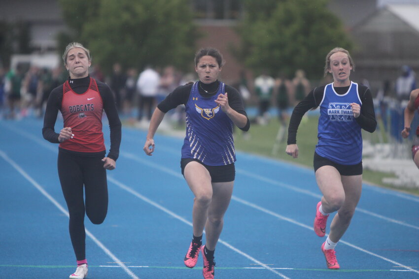 Lydia Clubb of Wright City, middle, competes in the 100-meter dash at the Eastern Missouri Conference championship meet on April 25 at Montgomery County High School. Clubb won the event with a time of 12.82 seconds. She also helped the 4x200 and 4x400 teams pick up victories. Theo Tate photo