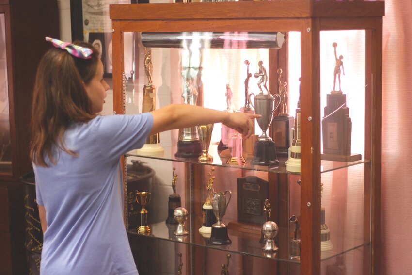 Emily Biter points out a trophy case at the Jonesburg Historical Museum on June 1. The museum, which has items that chronicle the history of Jonesburg, is open to visitors on the first Saturday of each month.
