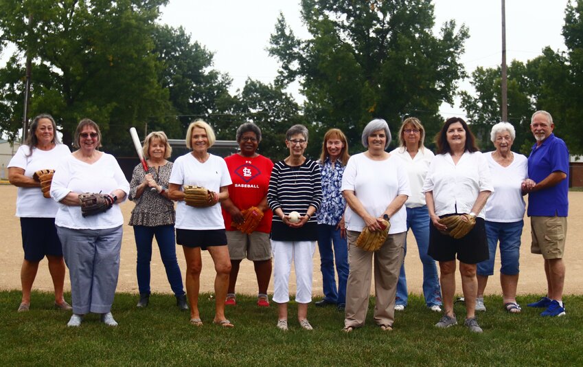 Members of the Warrenton Chic No 2 softball team, originally featured in the Aug. 21, 1969 edition of the Warren County Record, reunited Saturday, Aug. 24 to recreate their team’s original photo. 
Pictured left to right: Barbie Daly, Margie Dyer, Karen Buxton, Cindy Wright, Anita Houston, Midge Kellerhaus, Ruth Ann Womble, Charlotte Phillips, Chris Melkowski, Kandy Henderson, Team Manager Barbara Owenby and Bat Boy David Owenby. Not pictured: Sherri Wells and Beth Huff.