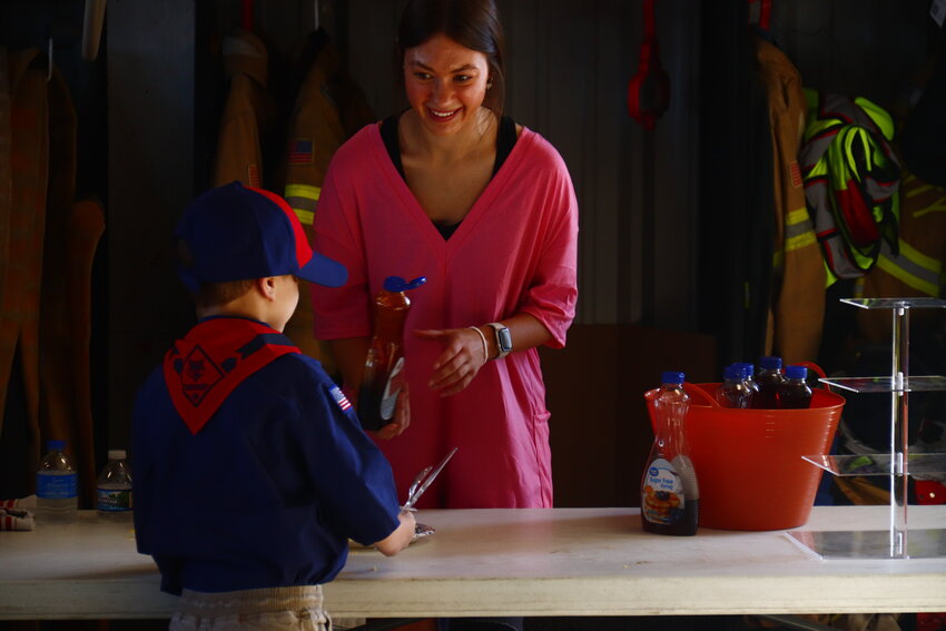 Pictured: Paige Kirn serves food at the pancake breakfast.