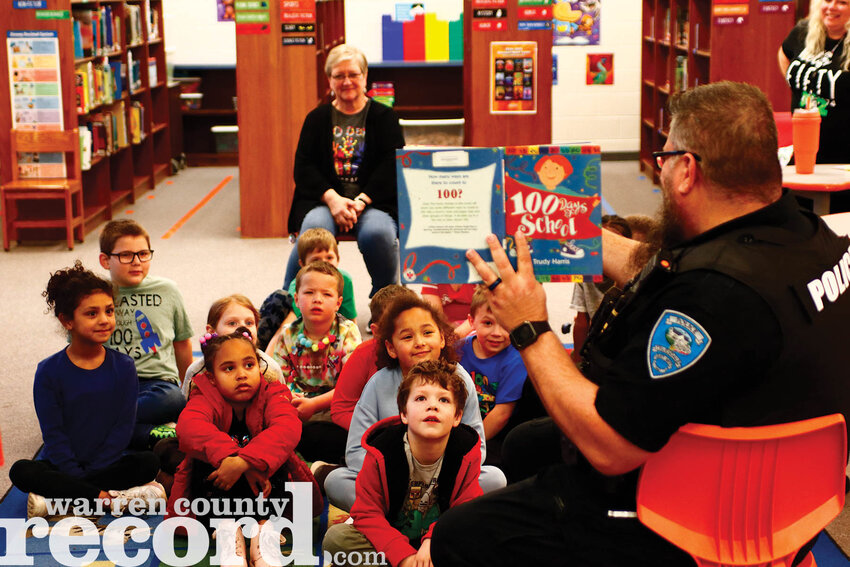 School Resource Officer Scott Taylor reads to Mrs. Franz' first grade class in the library on the morning of March 4.