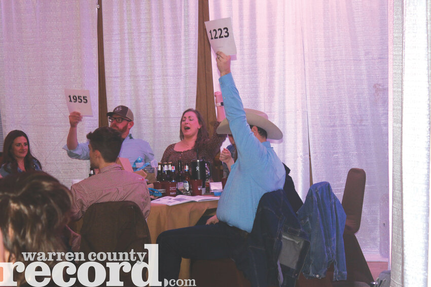 Wright City's Kyle Lewis puts in a bid for an auction item during the 25th Blue and Gold Scholarship Auction on March 15. This year's event raised $130,000 for potential Wright City High School seniors that will attend college.