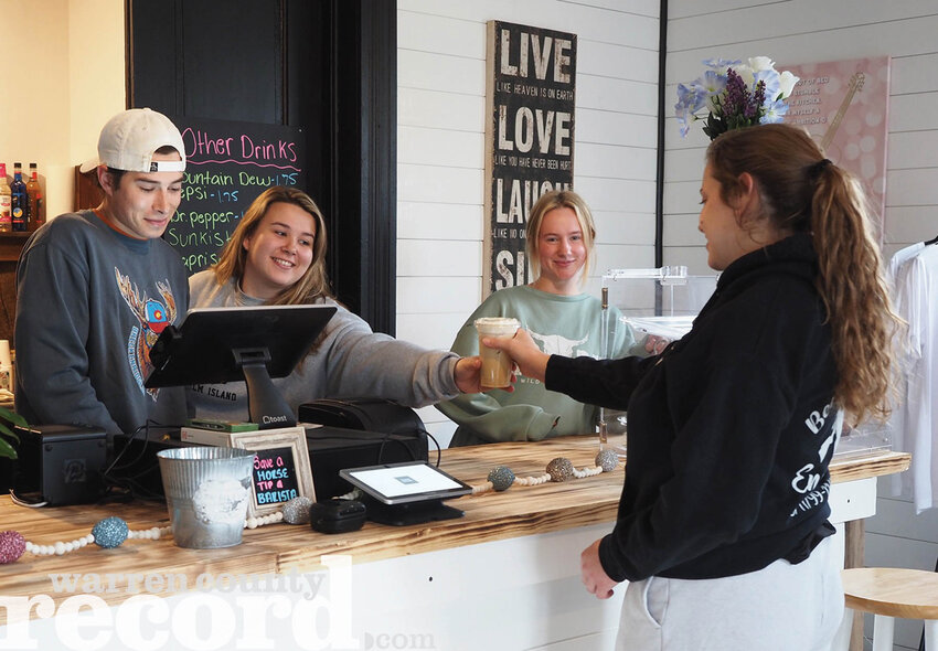 Country Grounds Coffee Company has opened in Marthasville at 201 Depot Street. Owners Justin Galvin, left, sister Olivia Galvin and partner Aspen Draeger are serving one of their signature drinks to local Kyla Engemann. They are closed Monday and Tuesday but are open the rest of the week. Breakfast items are available. Lunch will be added in the next few weeks.