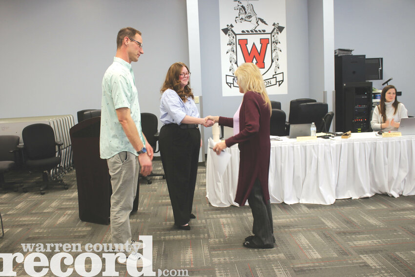 Stephanie Tibbets, middle, shakes hands with lucy Swailes after Tibbets and Keith Harbison were sworn in to the Warren County R-III Board of Education. Both Tibbets and Harbison will serve in their first term on the board.