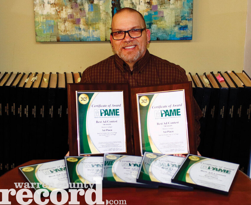 Westplex Media Group Production Manager Tim Hager pictured with his seven awards from the Missouri Press Advertising and Marketing Executives conference, which he won on April 10.