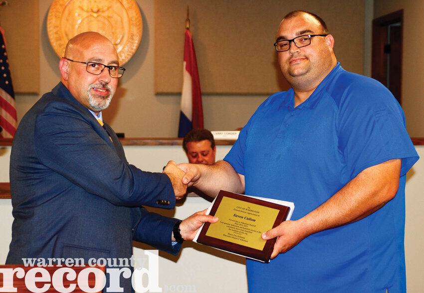 Outgoing Warrenton Alderman Steven Cullom, right, was presented with a plaque commemorating his service to the city by Mayor Eric Schlueter at the April 15 board meeting.