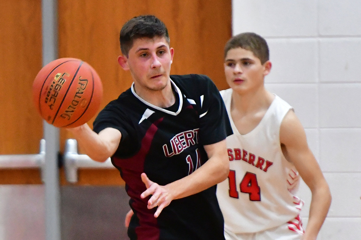 ON A SKID — Liberty Christian’s Cole Christian makes a pass during last Thursday's 81-55 loss at Elsberry.