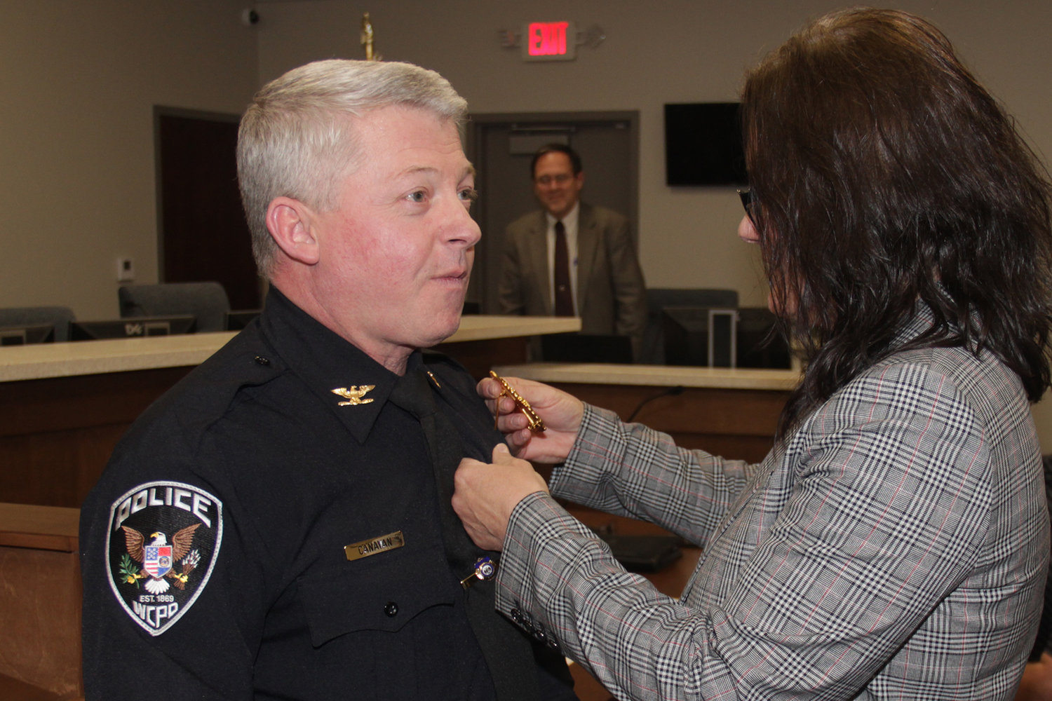 Tom Canavan has the badge of Wright City Police Chief pinned to his uniform by wife Renee Canavan after being officially sworn into office on Jan. 13 at Wright City Hall.