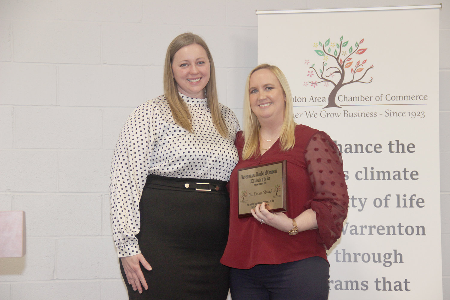 EDUCATOR OF THE YEAR — Carrie Strunk, right, receives the Educator of the Year award from Warrenton Chamber President Katie Joyce. Strunk is a curriculum coordinator who helped the Warren County R-III School District adapt to educate students during the COVID pandemic.