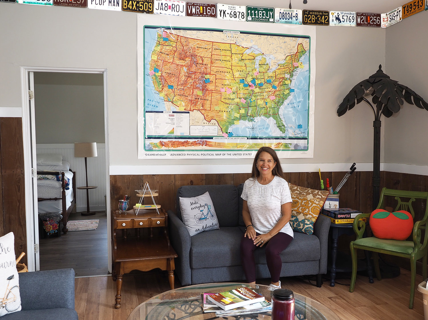 The Happy Apple Bicycle Bunkhouse is open for its second season. Bikers from the Katy Trail or other groups can rent a room or the entire house from May through August. Owner Joette Reidy is pictured here with a map that visitors can mark with their home state.