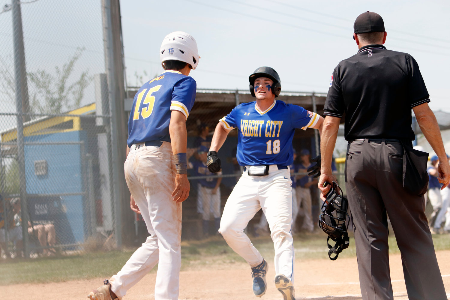Ian Wolff (right) celebrates as he crosses the plate during the third inning of Wright City's win over Bowling Green. Wolff and Logan McCartney (left) scored on the play.
