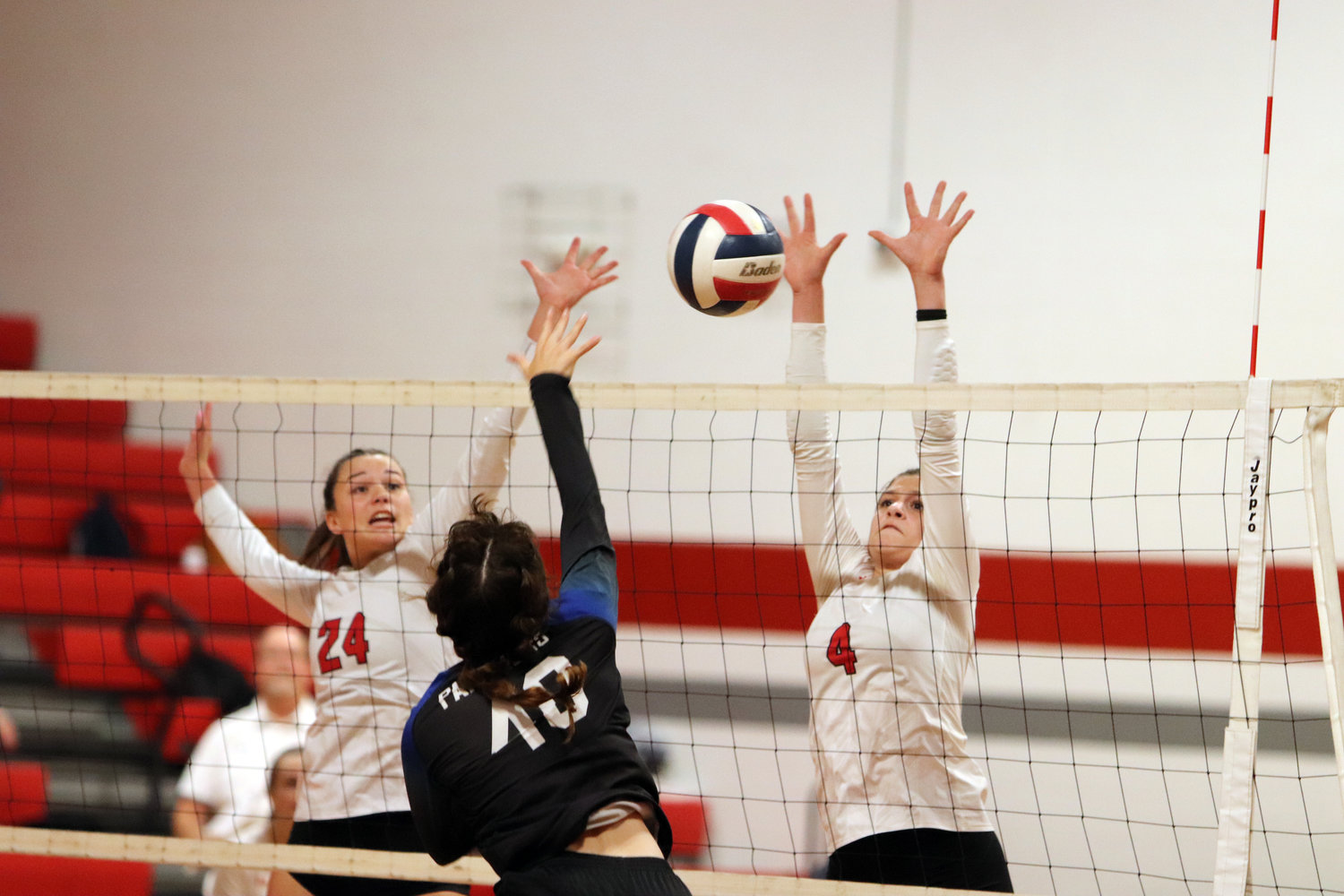 Zoe Klaus (left) and Rayne VanReed attempt to block the ball.