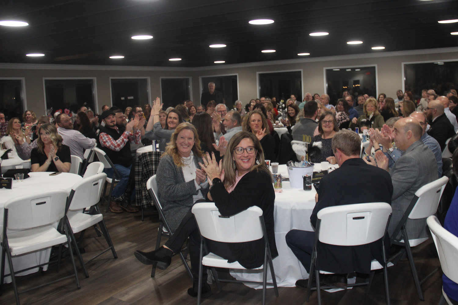 CHEERS FOR CHAMBER — Members of the Warrenton Area Chamber of Commerce, gathered for the Chamber’s 100th anniversary banquet Jan. 13, applaud during recognitions of the Chamber’s important contributors.