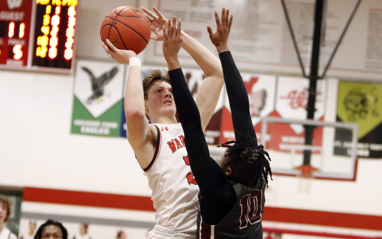 Tyler Oliver shoots over St. Charles West defender Nick Lewis during the first half of Friday night’s game. Oliver led Warrenton with 11 points.