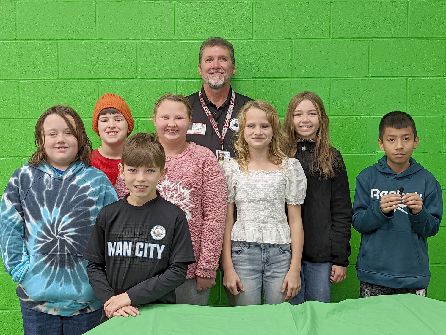 Warren County Emergency Management Director Jim Sharp joins the fifth grade news team at Rebecca Boone Elementary to help lead students in the Pledge of Allegiance.
