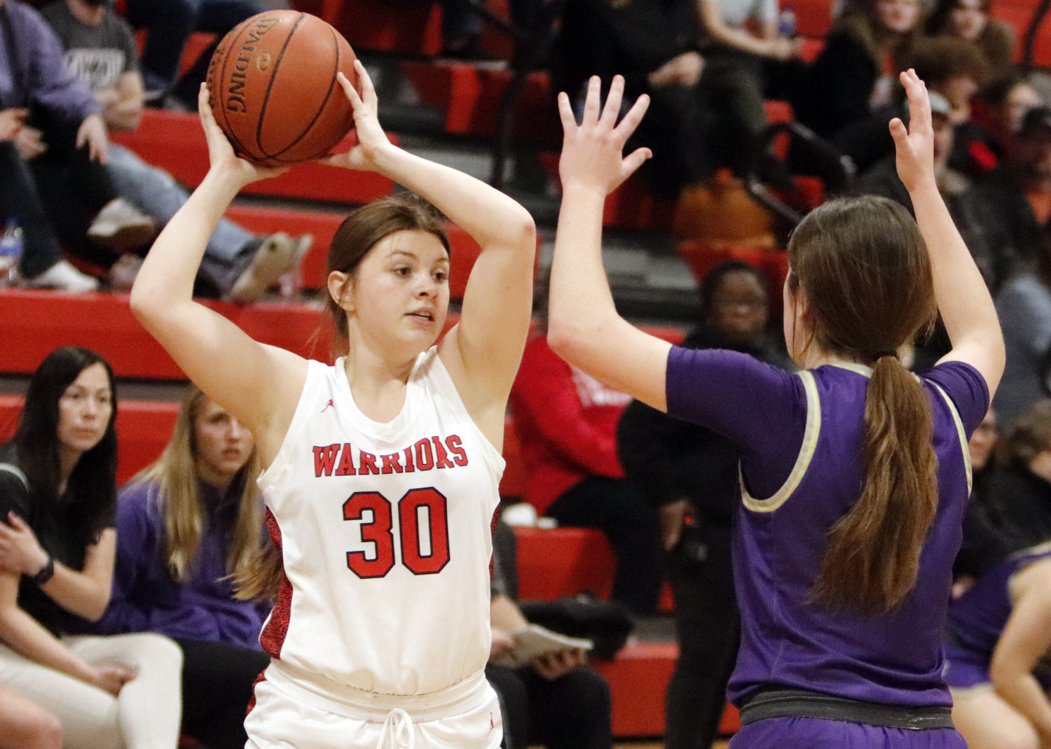Erin Klassing (left) looks to pass to a teammate during Friday night's win over Hallsville.