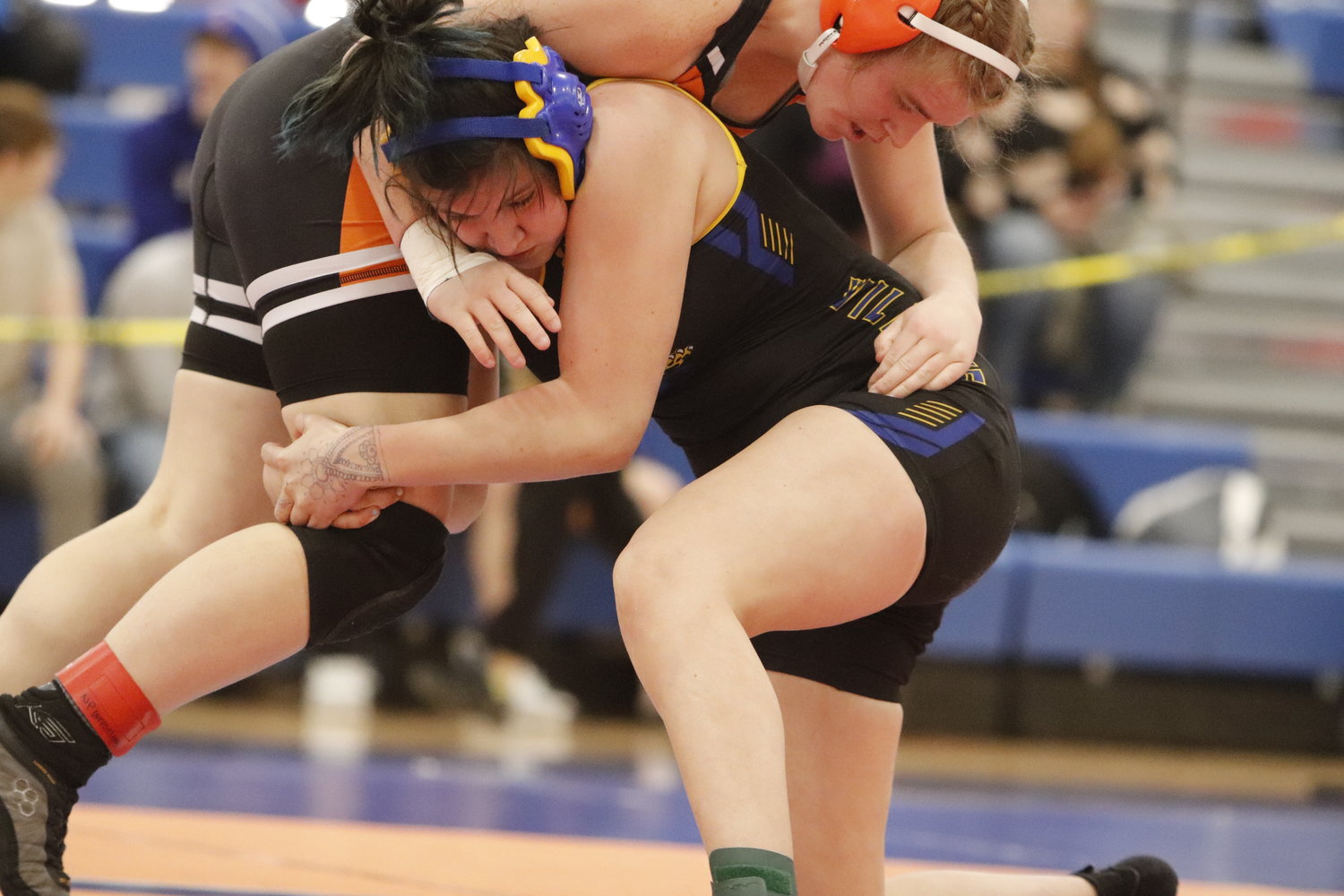 Wright City sophomore Caelyn Hanff (right) wrestles against Maddisyn Crawford of Kirksville during Saturday's district tournament. Hanff won the match and placed first in her weight class.