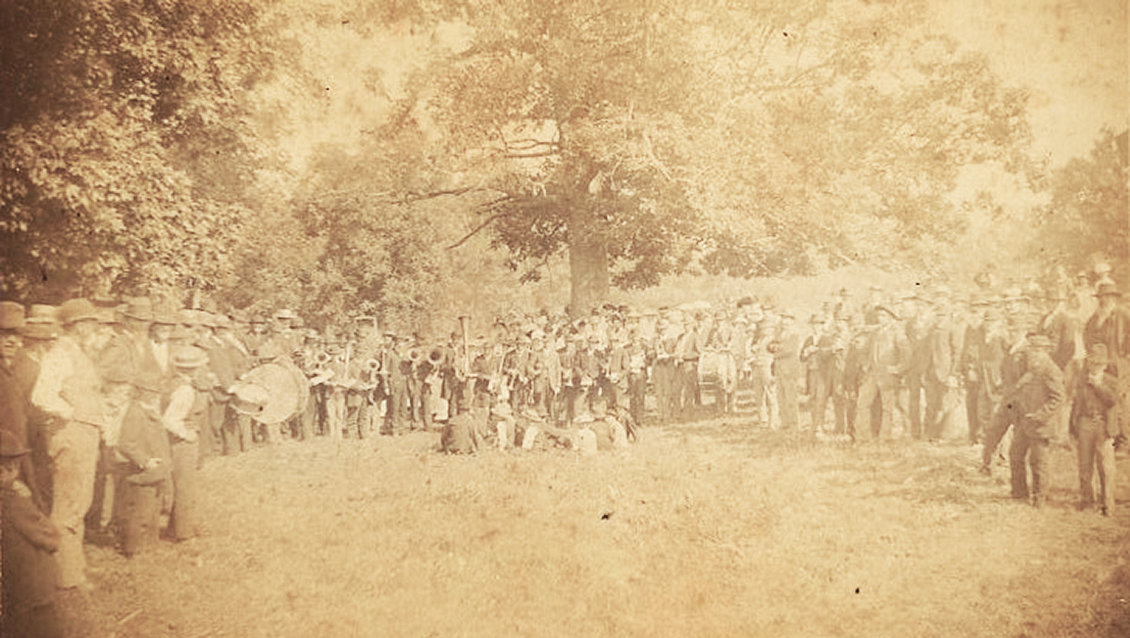 FIRE COMPANY PICNIC — A Fourth of July picnic was held in 1879 to recruit members to the Marthasville & Farmers Fire Company, including the Cornet Band pictured in the center. The photo was taken in Mittler’s Grove and is part of the Rusche collection provided by Cathie Schoppenhorst.