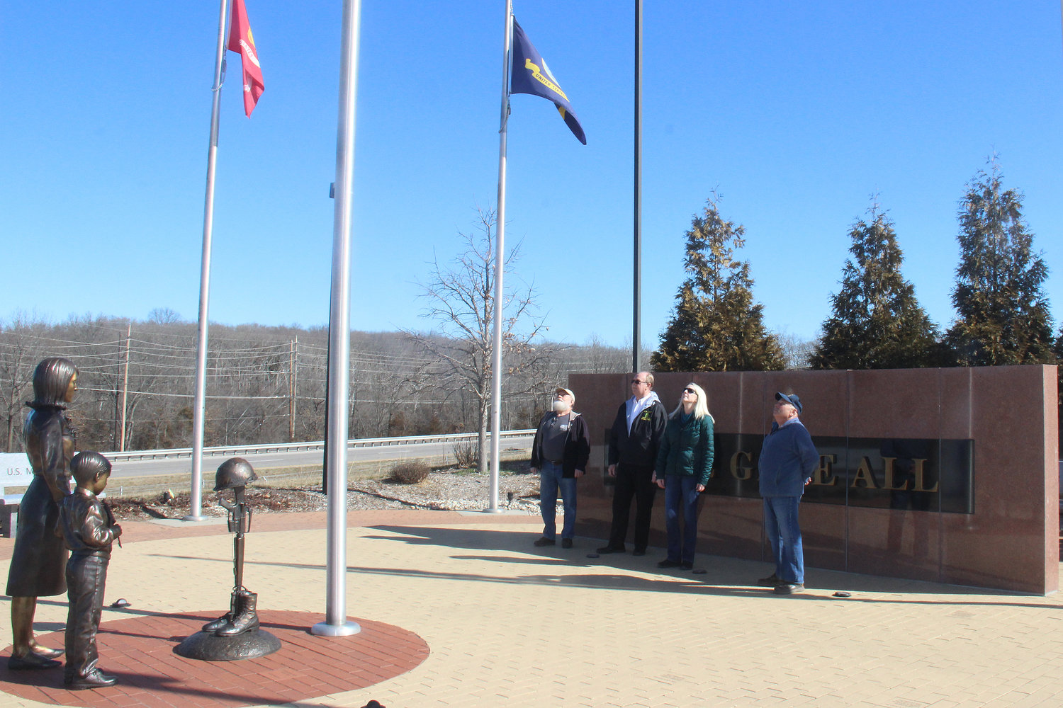 VISITING MEMORIAL — Tribute to Veterans Memorial board members and committee members visit the memorial site, located at the intersection of Veterans Memorial Parkway and Market Street in Warrenton. Pictured, from left, are Joe Vincent, Ralph Hellebusch, Kathy Daly and Rick Mantione.
