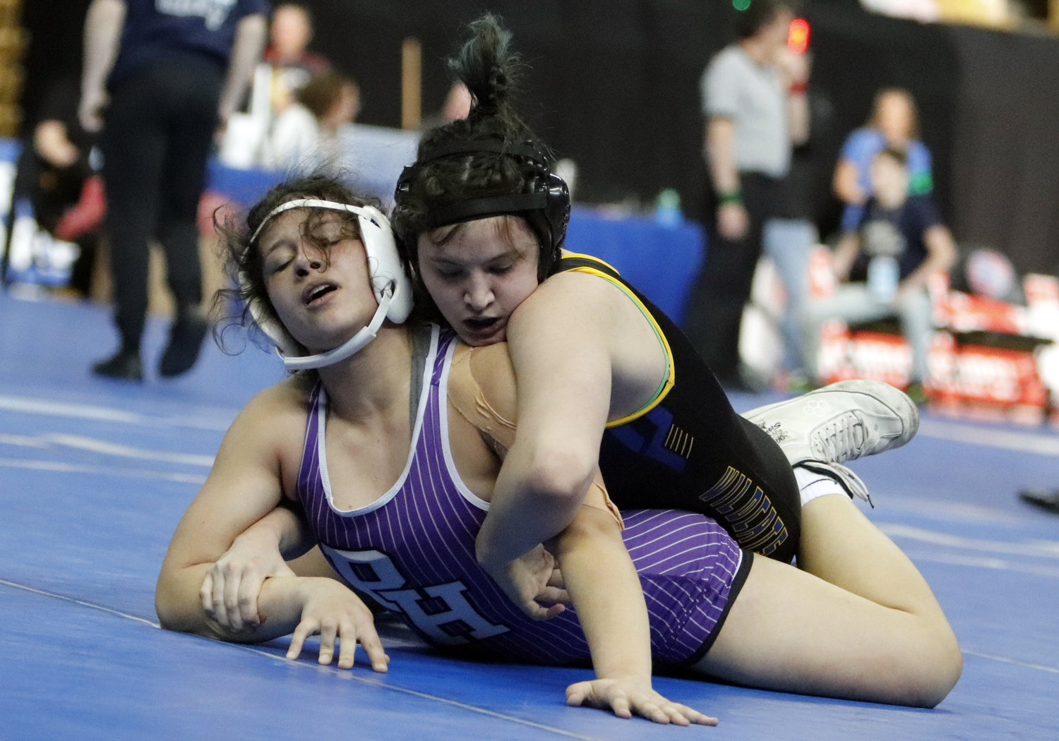 Caelyn Hanff (top) reaches for the arm of Pleasant Hill wrestler Alana Thielen during the third place match in the 170-pound weight class.