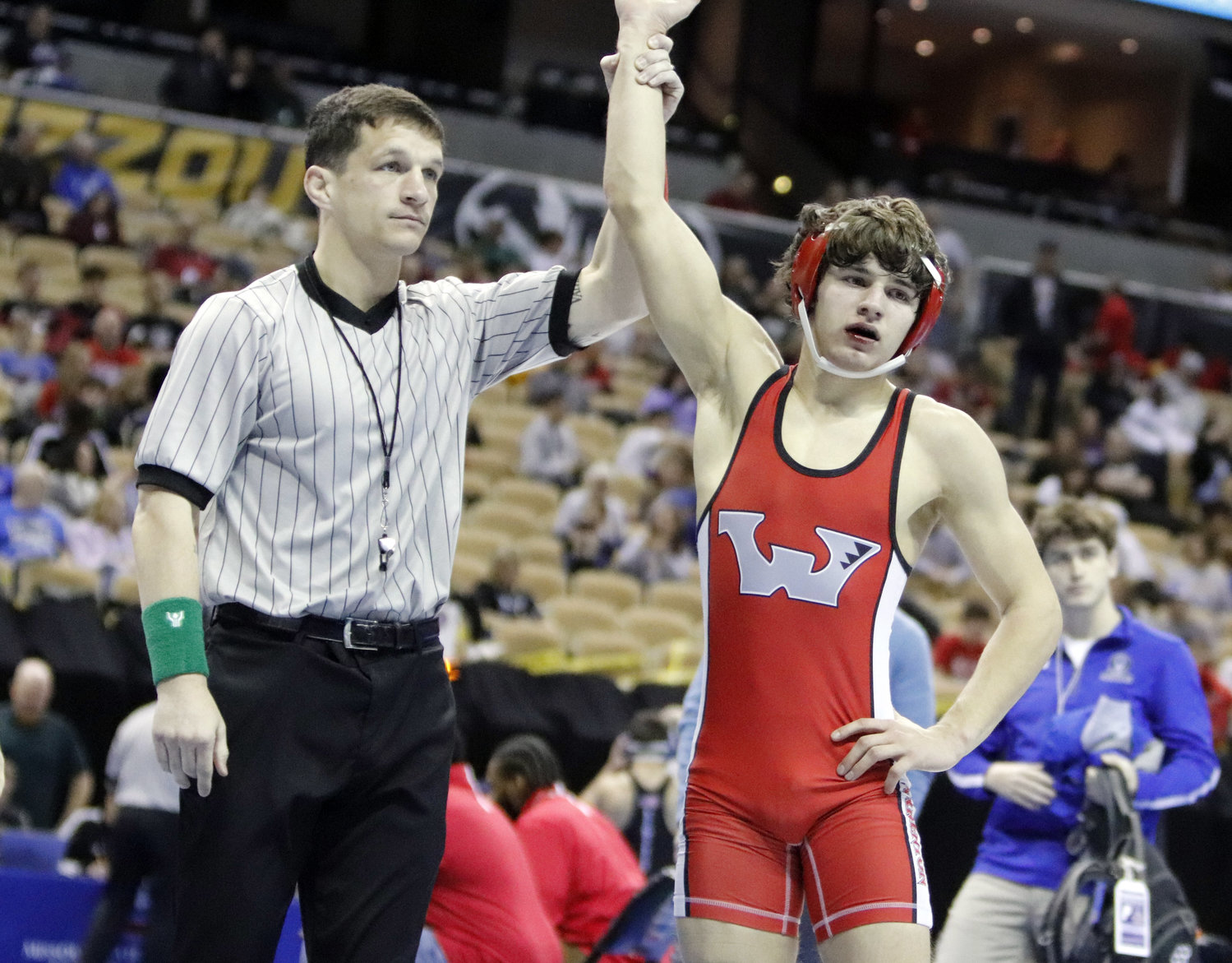 Noah Lohrmann's arm is raised after winning his first round match at the Class 3 state wrestlnig tournament.