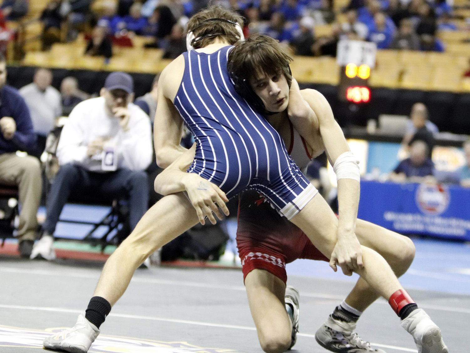 Manny McCauley (right) wrestles against Parker Lock of Helias Catholic during his opening match at the state wrestling tournament.