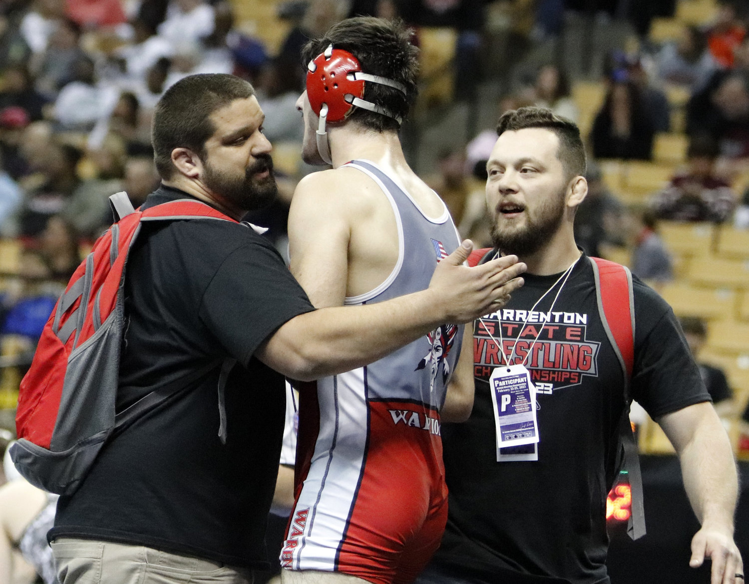 Warrenton coaches congratulate Jacob Ruff (middle) after his win in his quarterfinal match.