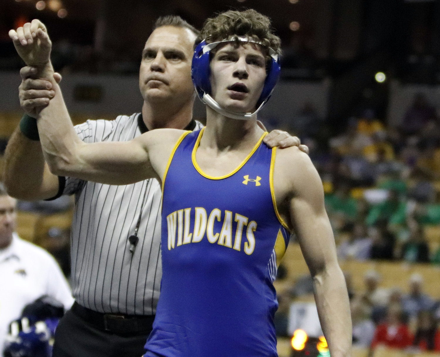 Wright City senior David Riggs' arm is raised by an official after winning a match at the state wrestling tournament.