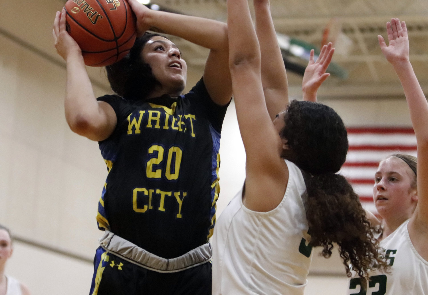 Wright City senior Jasmin Simpson (left) shoots a contested layup during Wright City’s loss to Orchard Farm.