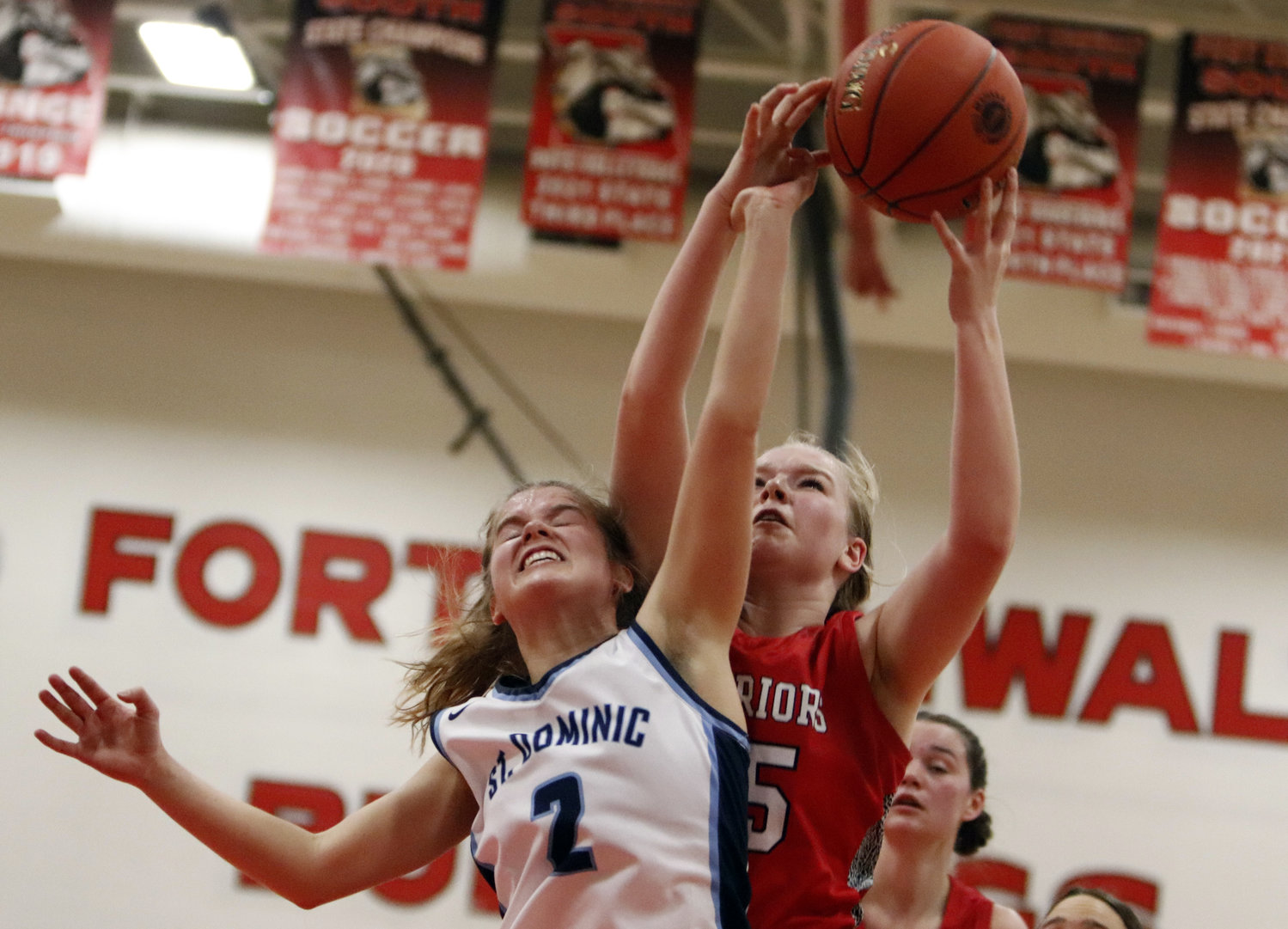 Warrenton junior Sophi Meuller (right) brings down a rebound over St. Dominic guard Anna Burcham during the first half of last week’s district quarterfinal matchup at Ft. Zumwalt South High School.