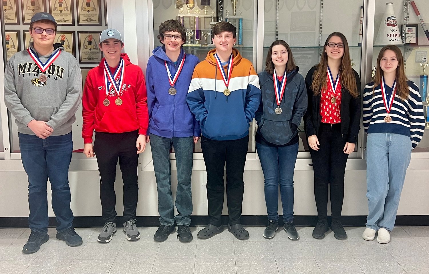 WARRENTON MEDALISTS — Seven of eight Warrenton Academic Challenge regional medalists pose with their medals. Pictured are, from left: Grant Buechner, Owen Thompson, Roy Briggs, Luke Rausch, Katie Shramek, Alice Briggs and Abby Palmer. Not pictured: Merrick Owens.