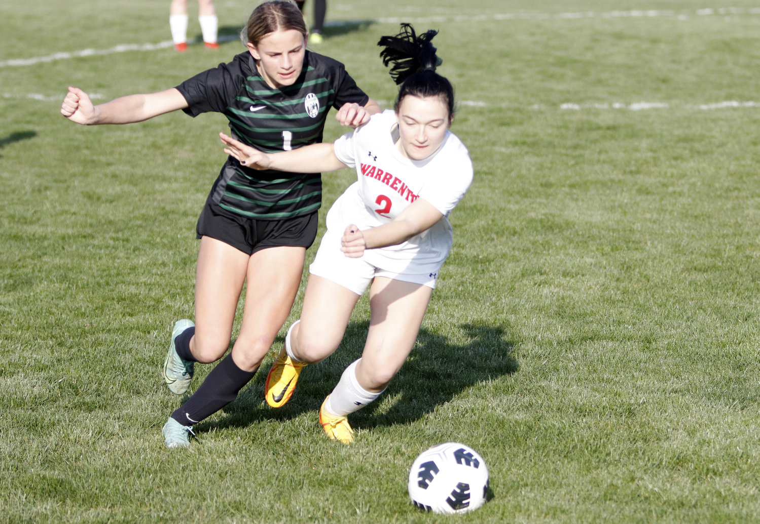 Warrenton junior Kylie Overkamp (right) battles for possession of the ball during Tuesday night’s game.