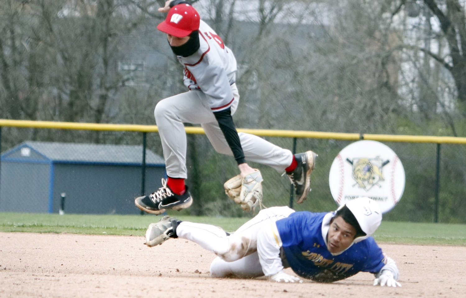 Warrenton shortstop Colin Disilvister (top) jumps over Duan McRoberts after tagging out McRoberts at second base during last weekend's game.