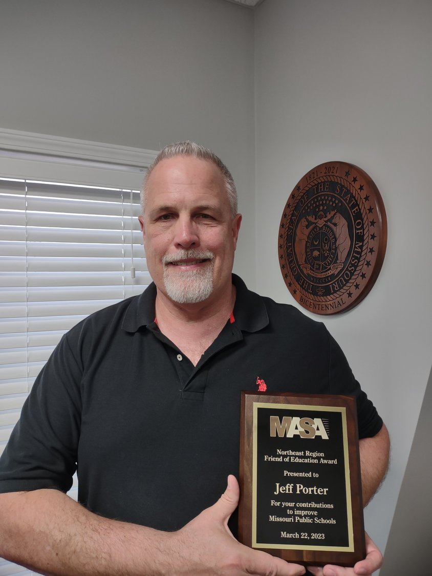 Montgomery City resident Jeff Porter poses with his Friends of Education award he received from the Missouri Association of School Administrators on March 22.