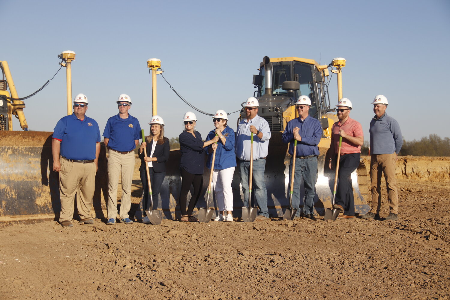 Representatives of the Wright City School District pose with shovels during the groundbreaking ceremony last week. Those shown are, from left: Assistant Superintendent Jeremy Way, Assistant Superintendent Doug Smith, board members Beth Dean, Heidi Halleman, Mary Groeper, David Mikus, Austin Jones, Kyle Lewis and Superintendent Chris Berger.