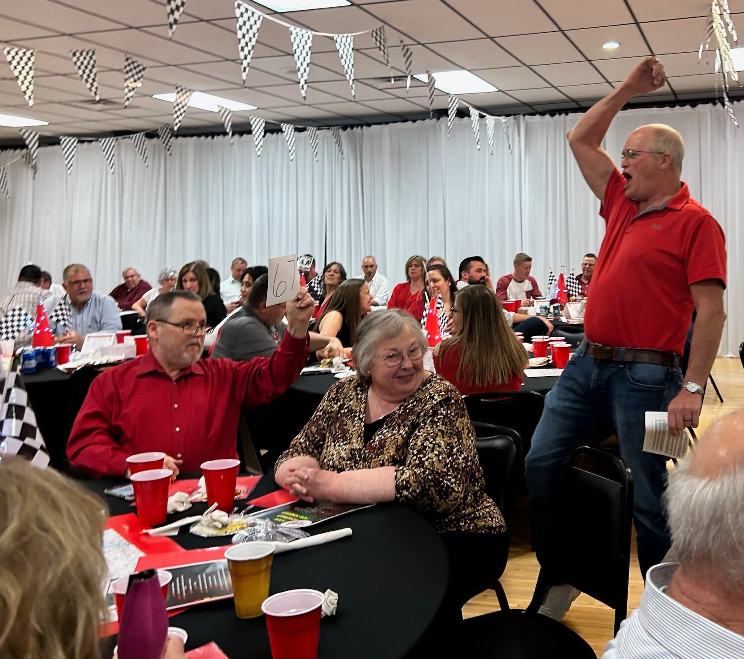 AUCTION TIME —  Eddie Meyer, right, calls out a high bidder during the WISE Foundation fundraiser on Saturday night, April 15.