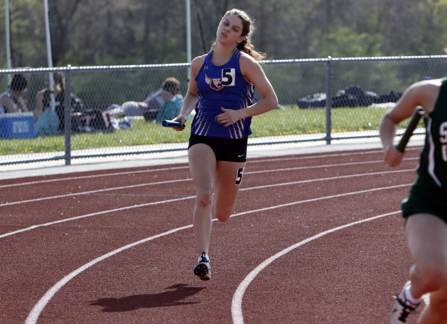 Elizabeth Riggs runs her portion of a relay race at last week's Wright City Invitational.