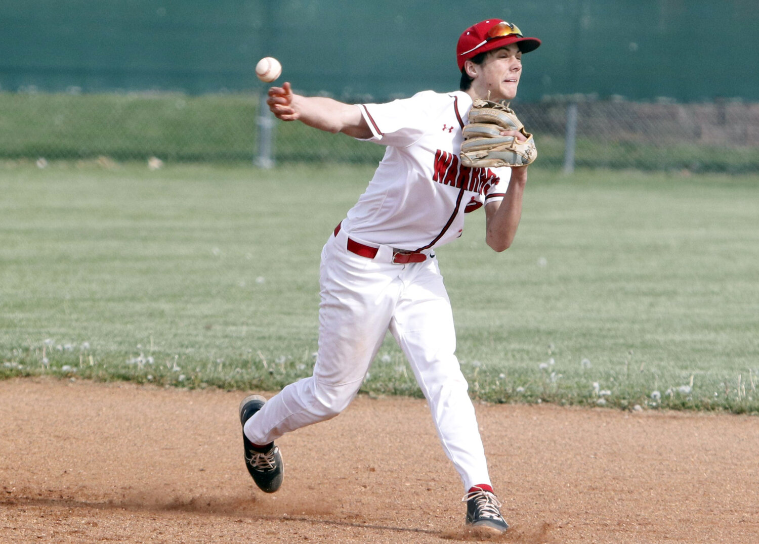 Colin Disilvister throws to first base to complete a double play during the first inning of Warrenton's loss to St. Charles West.