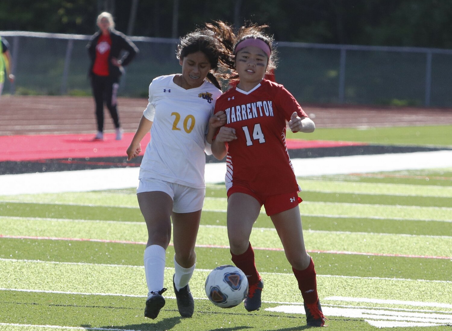Wright City junior Andrea Lopez Luna (left) battles with Warrenton's Lana Le for possession of the ball during Monday's game.