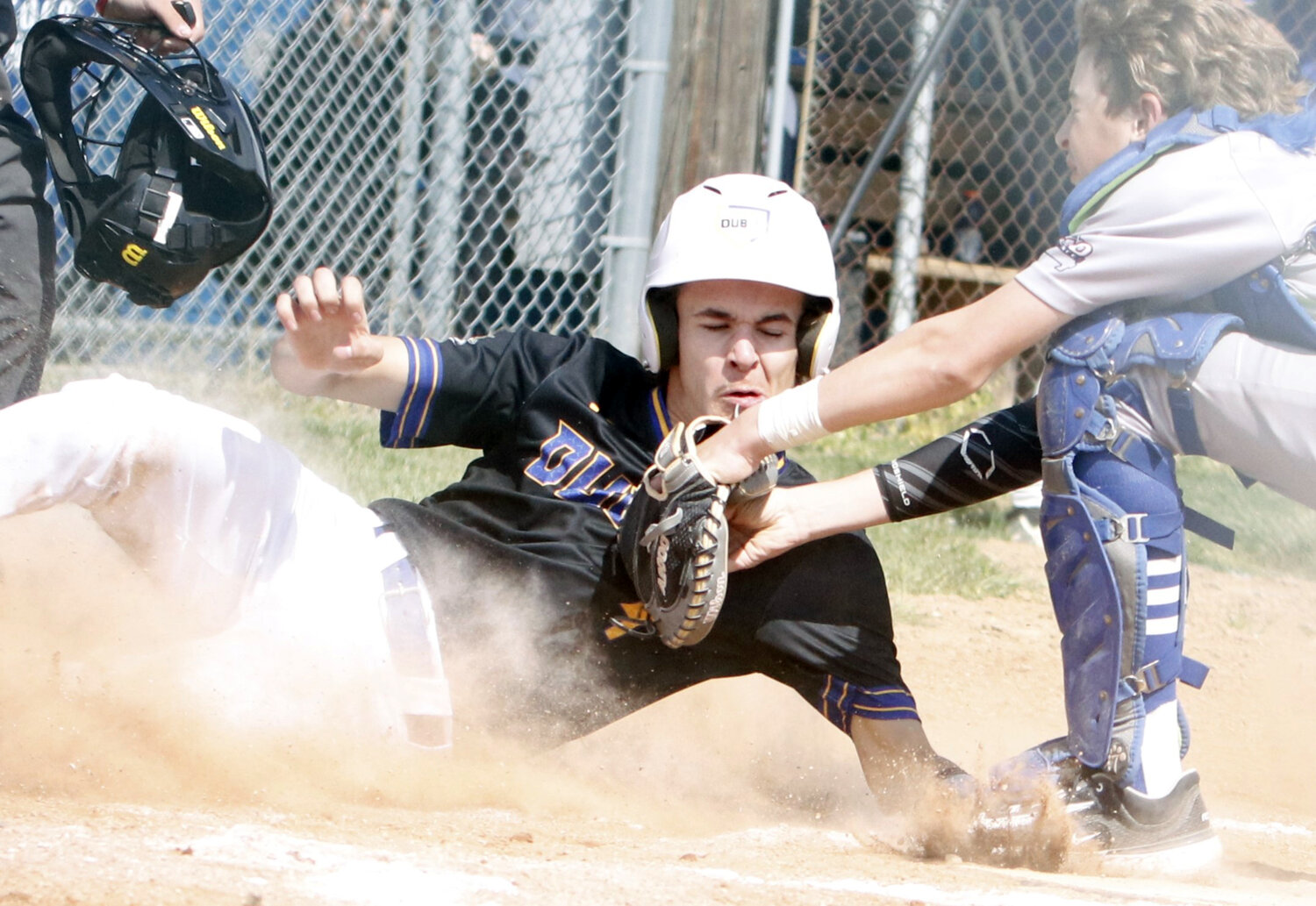 Jake Mitts slides into home plate during last week's game. Mitts was called out on the play.