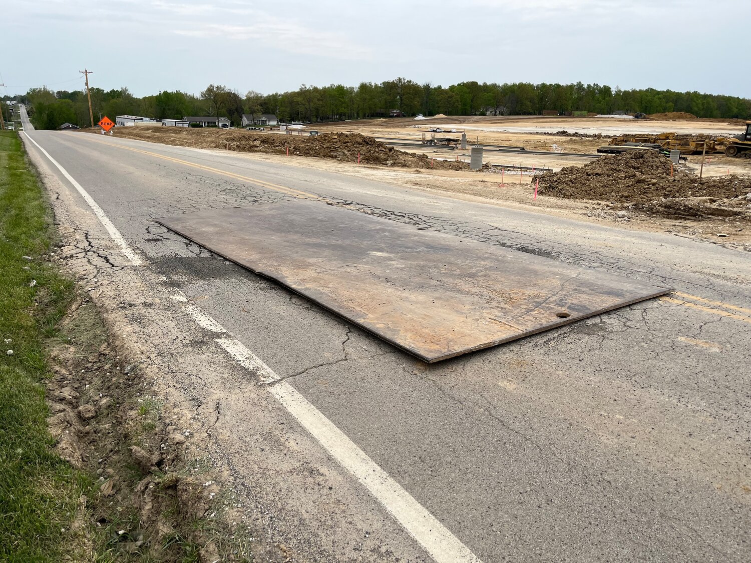 A TEMPORARY FIX - Several steel plates cover the most serious damage caused by trucks entering the construction site of the new Wright City high school on Roelker Road.