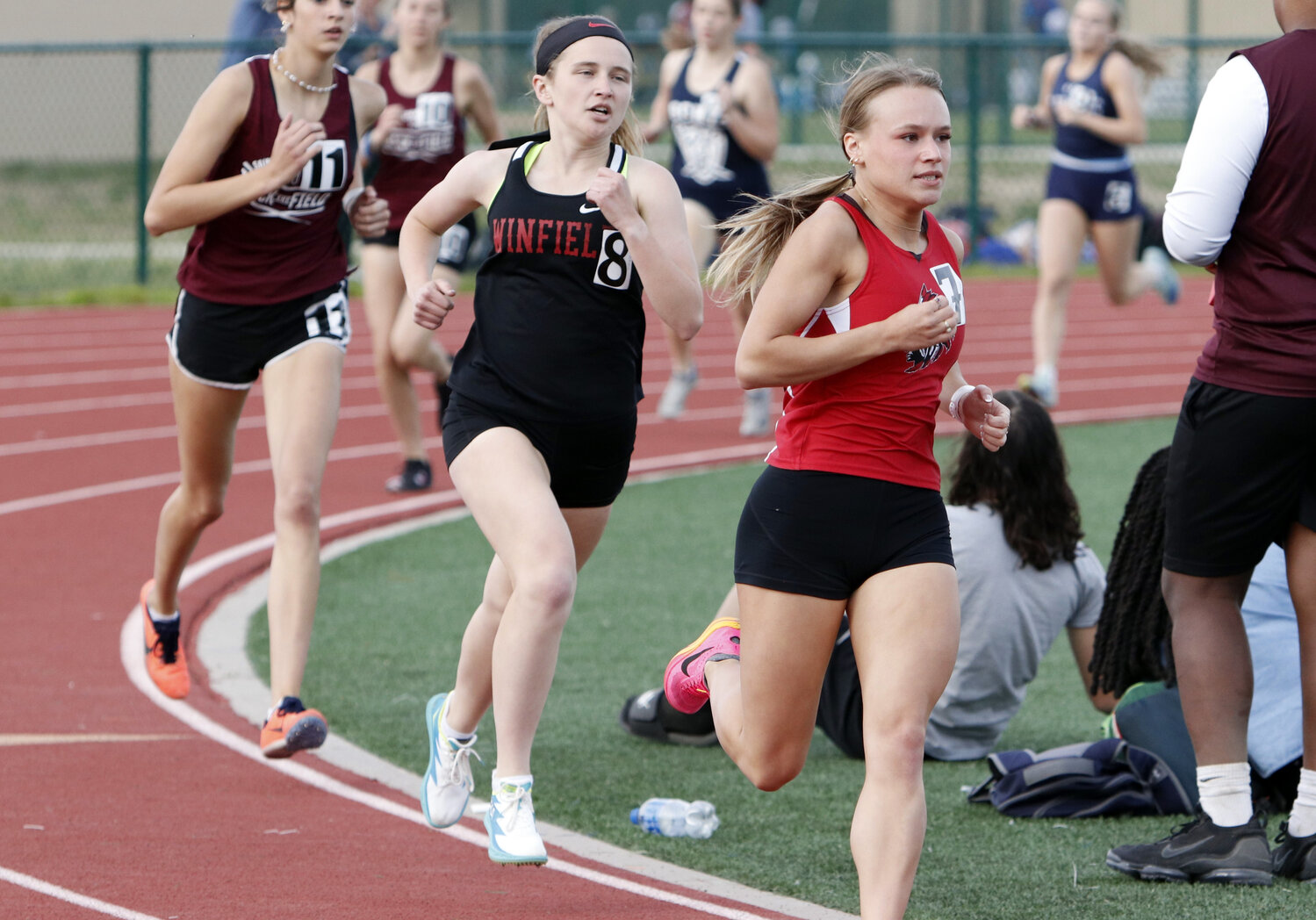 Madelyn Marschel (right) leads a pack of runners during the girls 800-meter run.