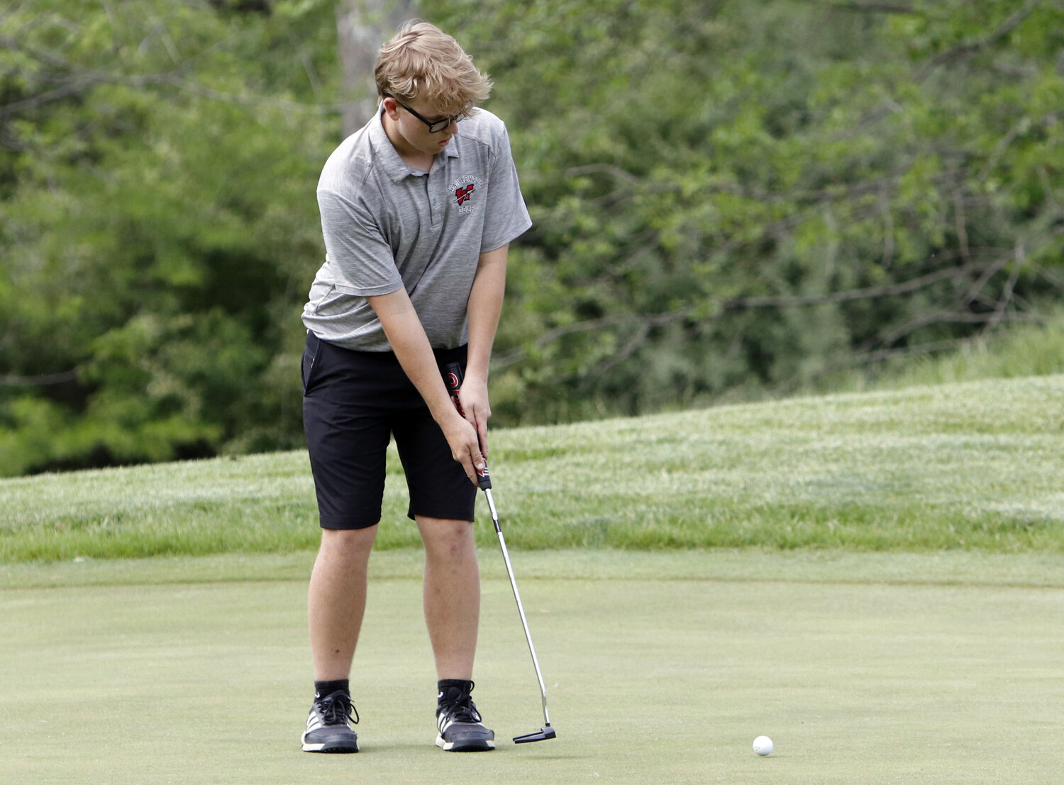 Ethan King follows through on a putt during Monday's Class 4, District 2 golf meet.