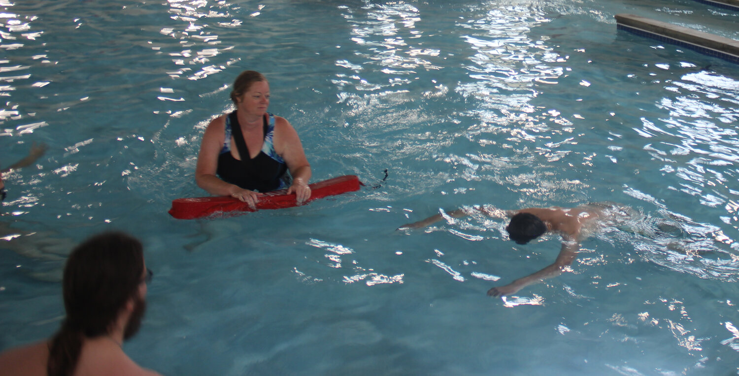 Lifeguard candidate Tamara Wurth begins practicing a water rescue during the May 19 training. She was "saving" fellow lifeguard candidate Jacob Nagel.