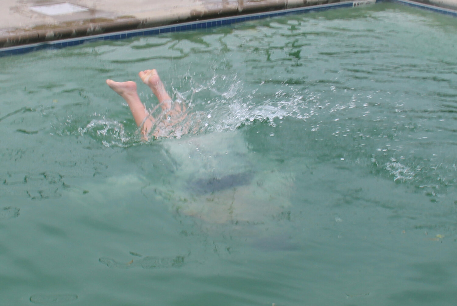 Nathaniel Kutsch dives in head first with nary a splash as he prepares to retrieve the brick from the bottom of the 12-foot pool.