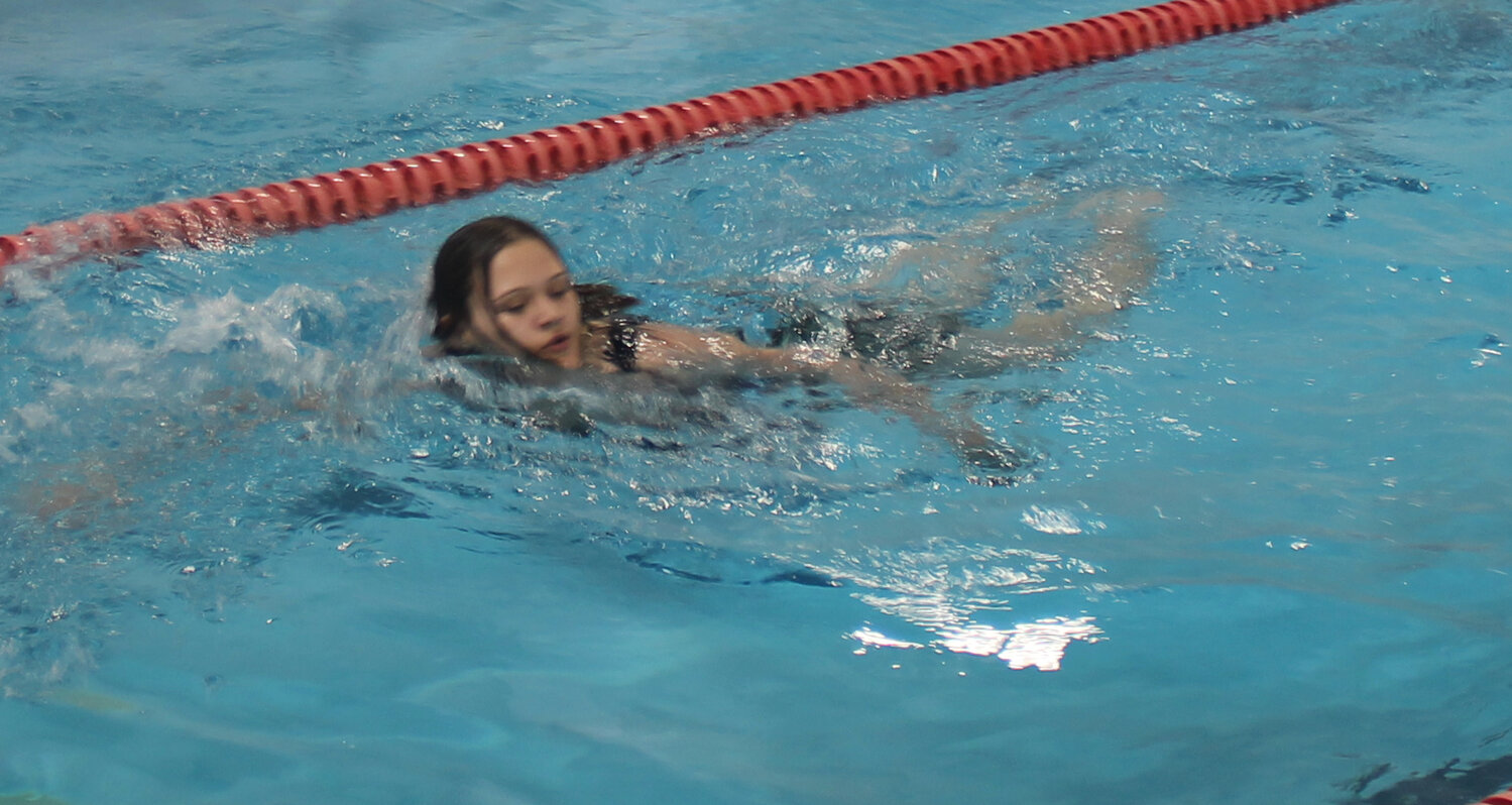 Miakoda Rhodes swims laps as a warm up for the May 19 training. Rhodes was one of the five lifeguard candidates.