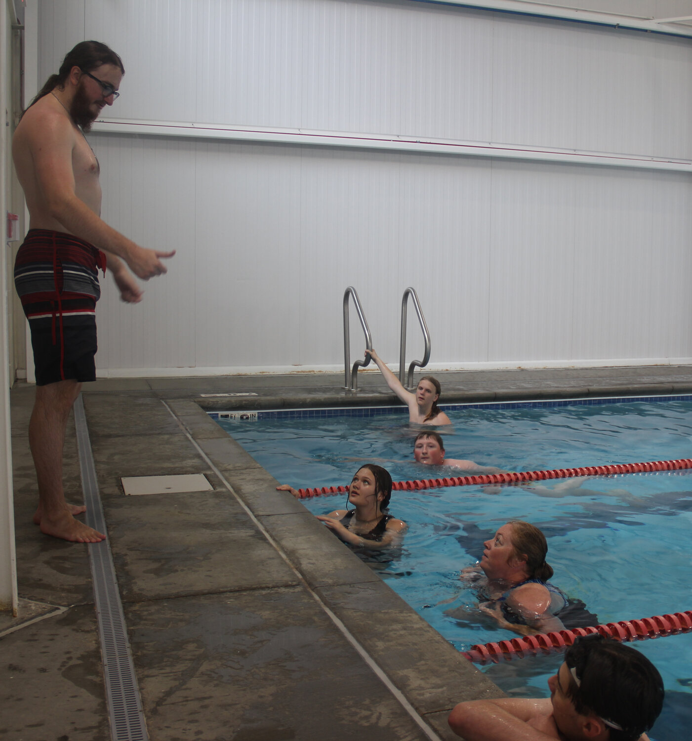 Cole McBride gives the five lifeguard candidates a thumbs up after they finished swimming their warm-up laps on May 19.