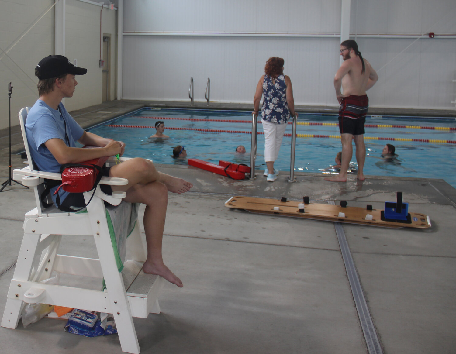 Lifeguard Nathanial Kutsch watches as Lisa Kramer and Cole McBride talk to the five lifeguard candidates on May 19.