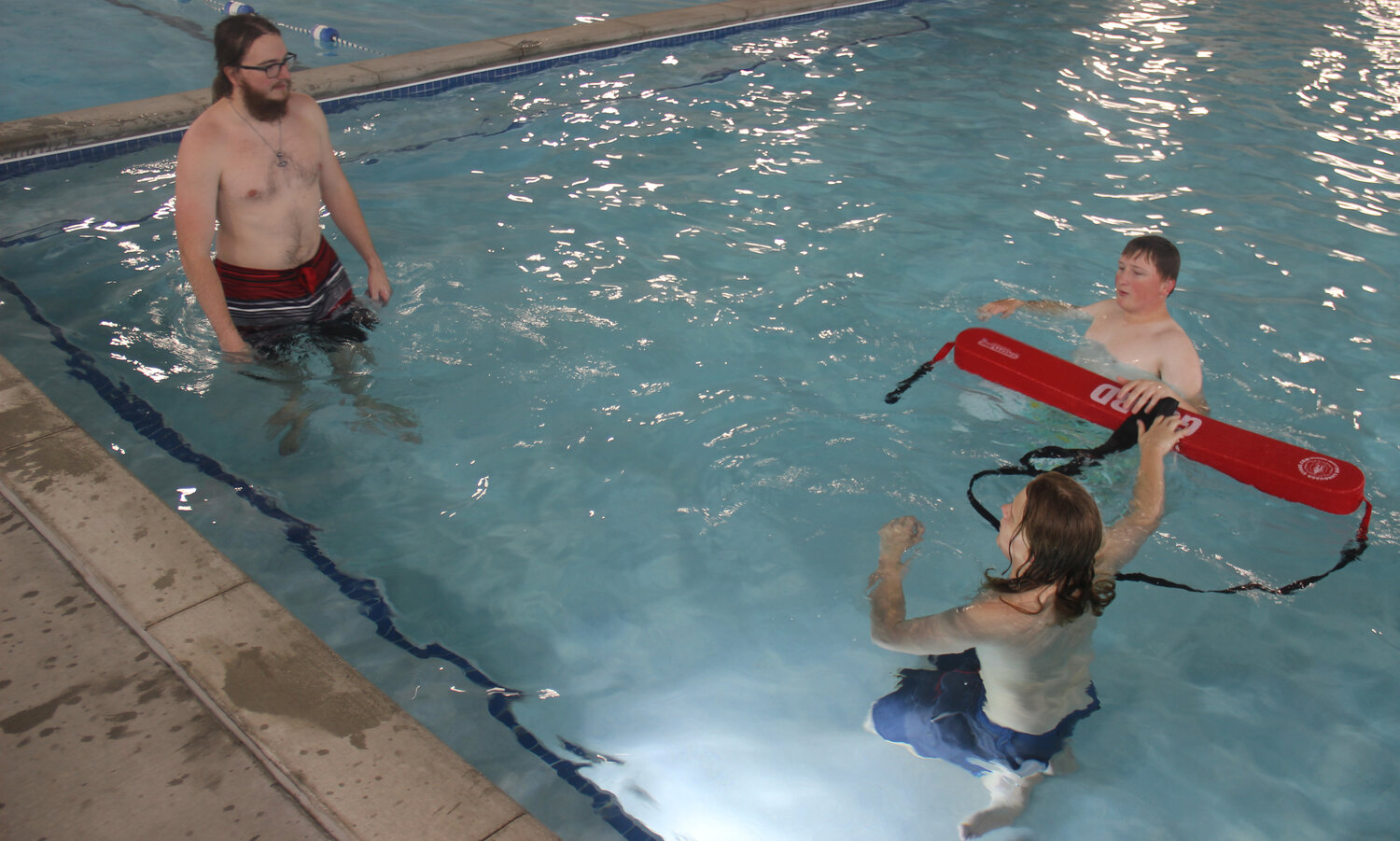 Instructor Cole McBride works with Hudson Grube and Cooper Stone during lifeguard training on May 19.